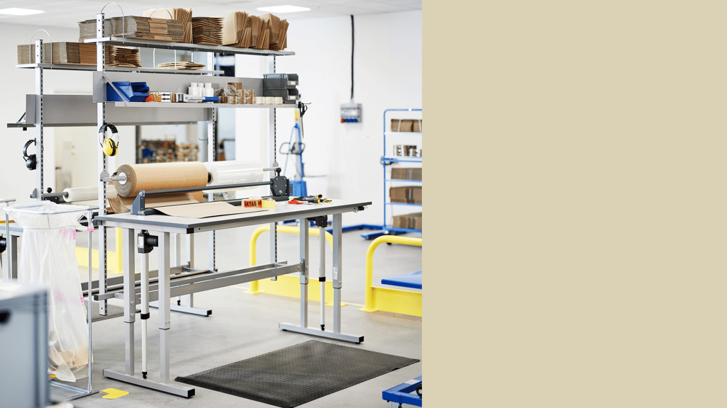 Height adjustable workbench set up as a packing station in a dispatch area