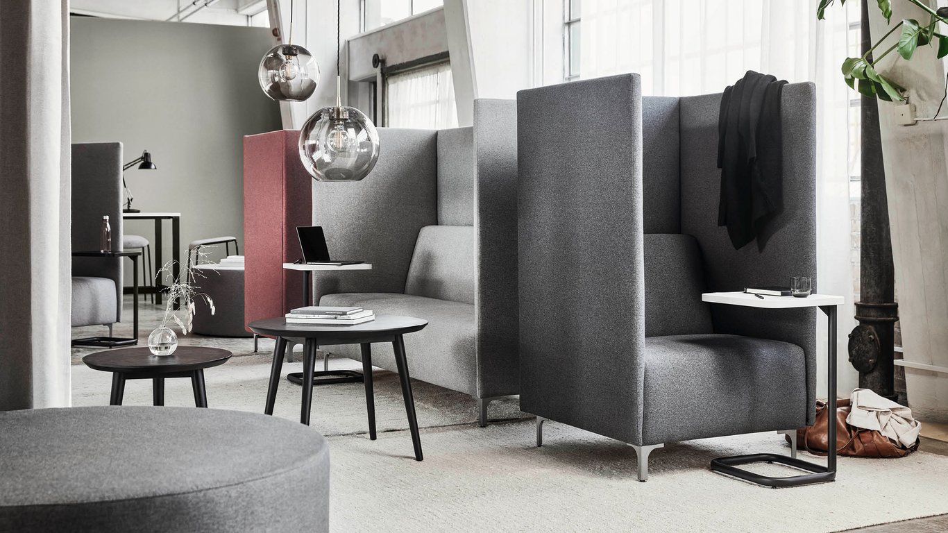Office lounge with high sided armchairs and coffee tables