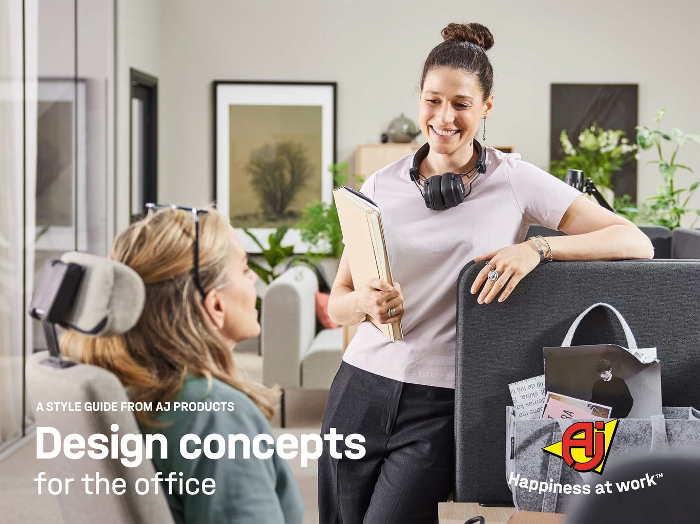 Brochure cover for Design concepts for the office from AJ Products. Two women having a conversation at a desk in an office.
