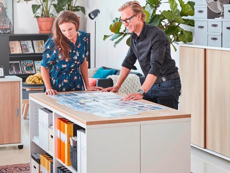 two people looking at something on the table