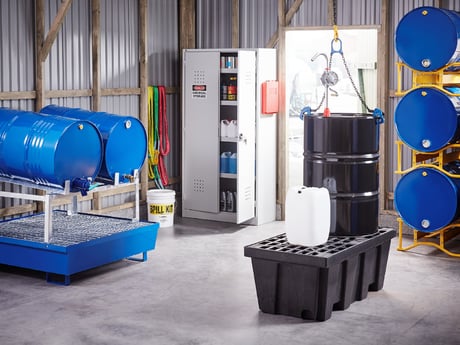an industrial or warehouse setting with various containers for storing and handling hazardous materials