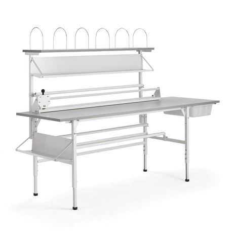 Fully equipped packing station with storage shelves and holders for packaging