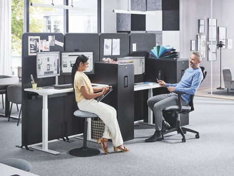 Person sitting at their desk and taking a call using a headset