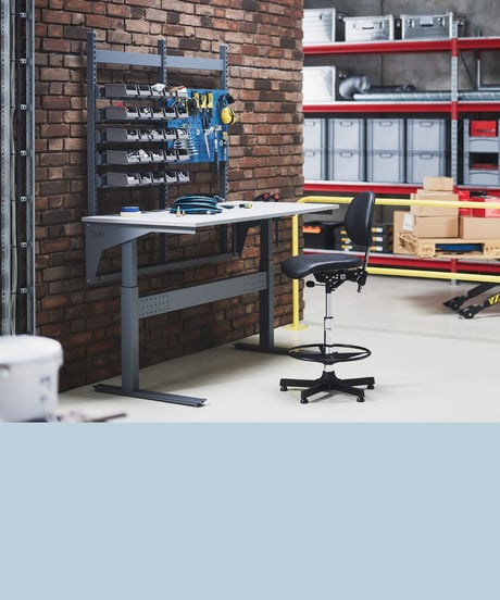 Werkbank met werkplaatsstoel in magazijn