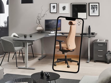 Office with a phone in the foreground showing an AR office chair