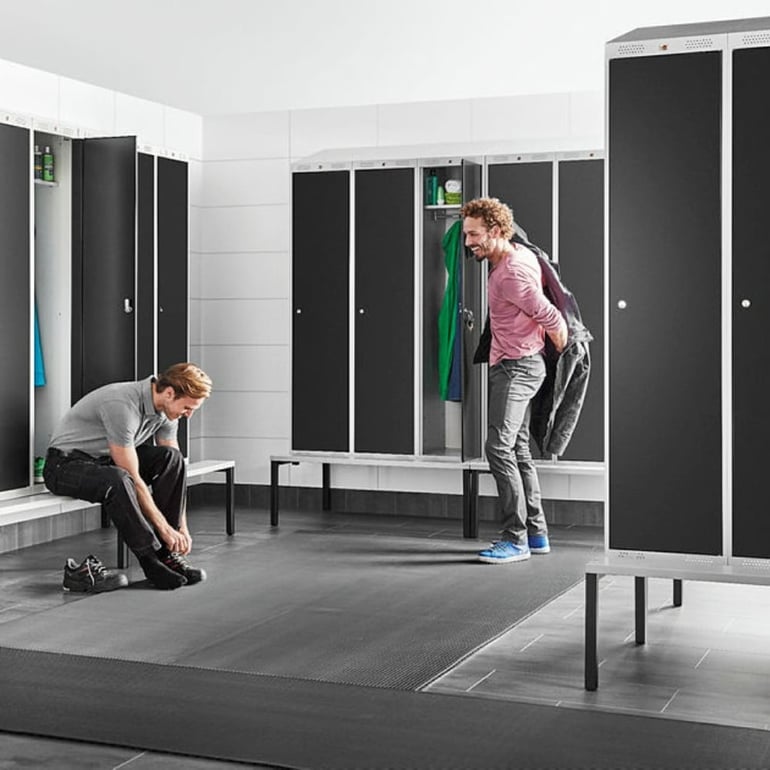 black gym locker with bench in a changing room