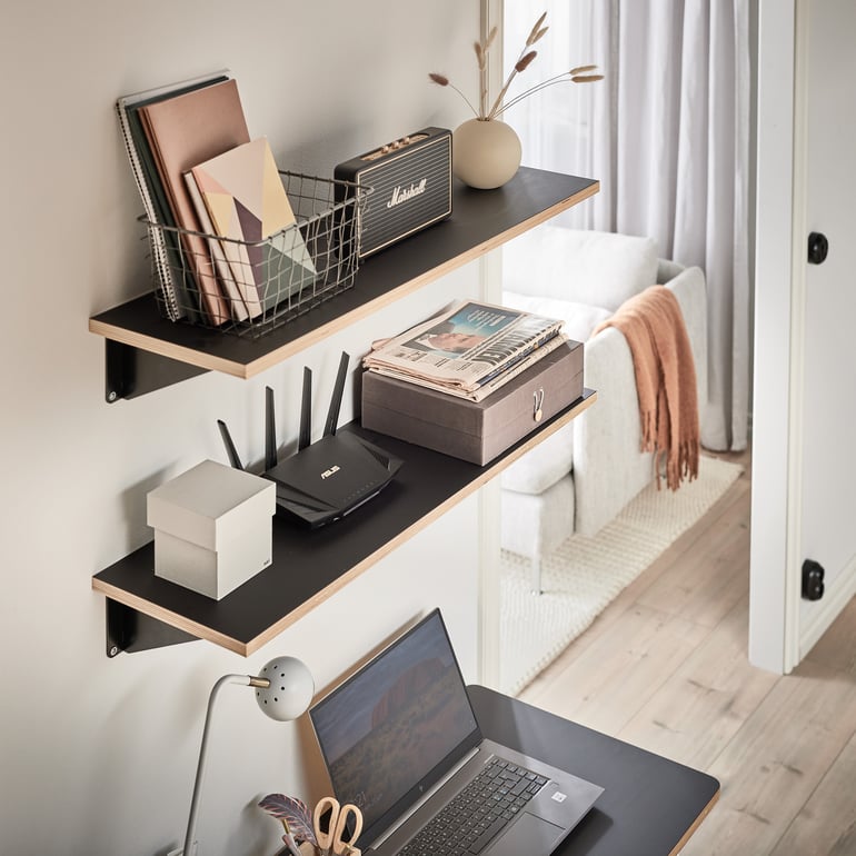 wall shelves with black brackets mounted in a  wall