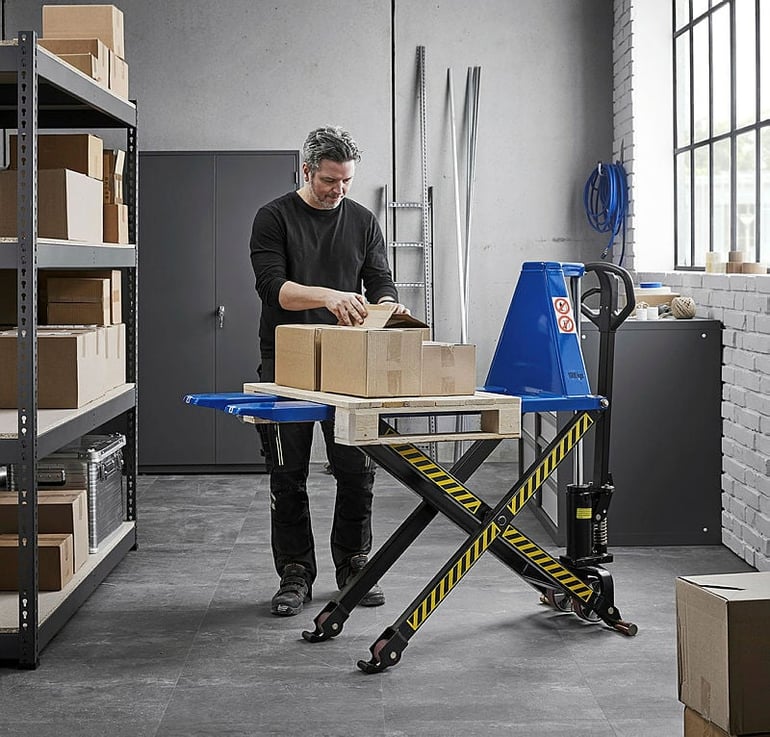 A man working with a group of boxed lifted on a pallet with the High lift pallet truck ACTIVE