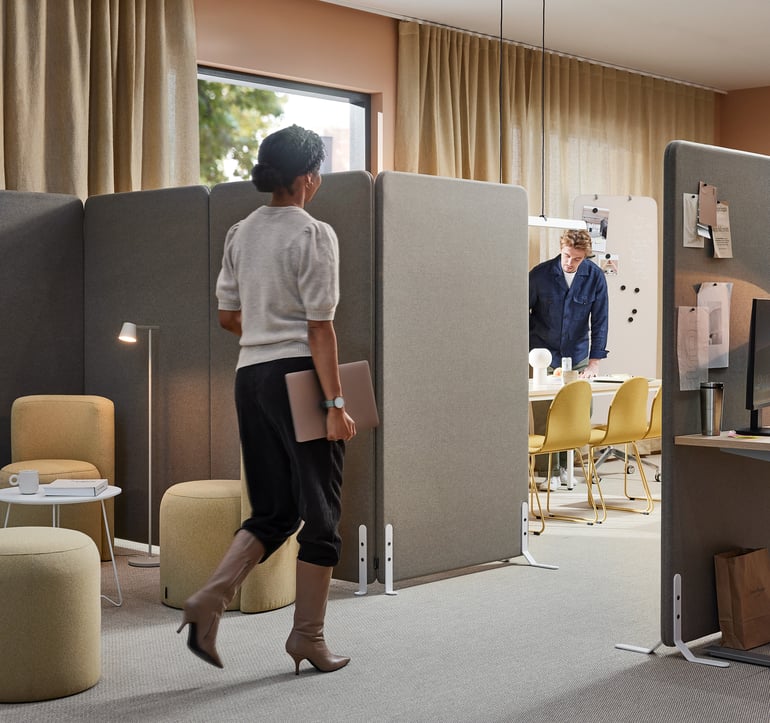 a lady walking through the different departments of an office