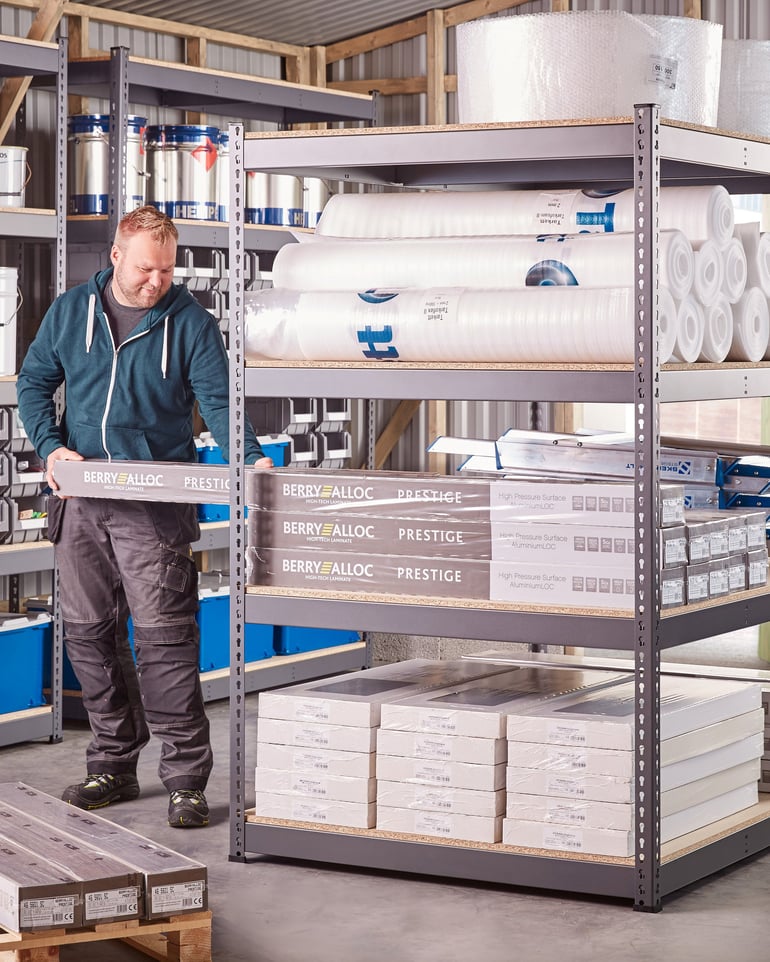 Warehouse worker retrieving goods from a warehouse shelf