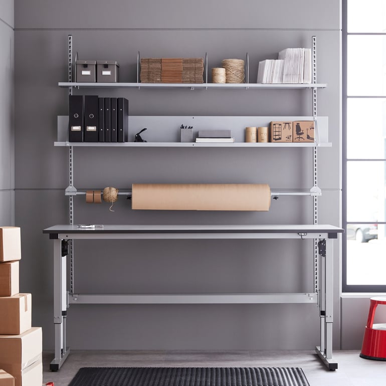 Packing station with shelves, workbench and packaging holder