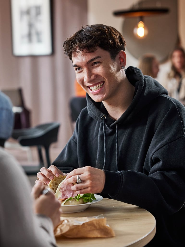a smiling staff member taking a lunch break