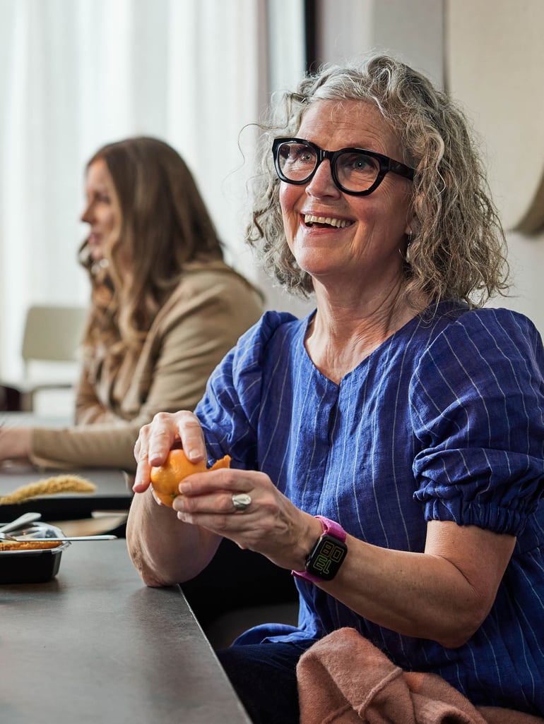 a smiling staff member taking lunch in the canteen area