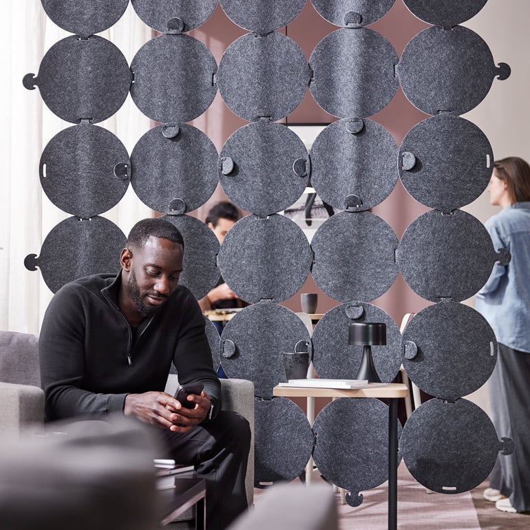 a staff member checking his phone in a quiet area