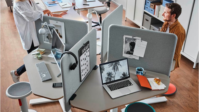 Office space featuring desks and desk screens.
