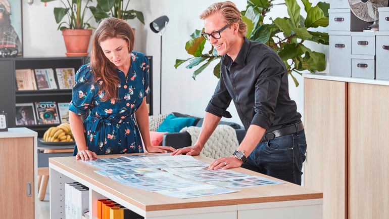 Two people standing up and working