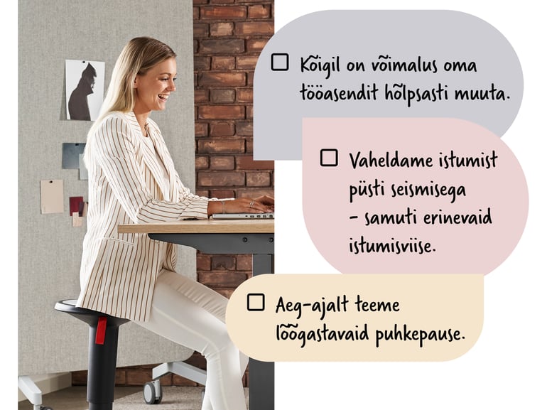 Naine istub reguleeritava kontorilaua taga tasakaalutoolil