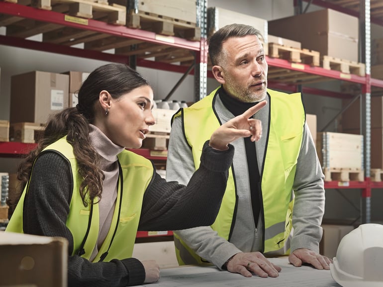 People having a meeting in warehouse