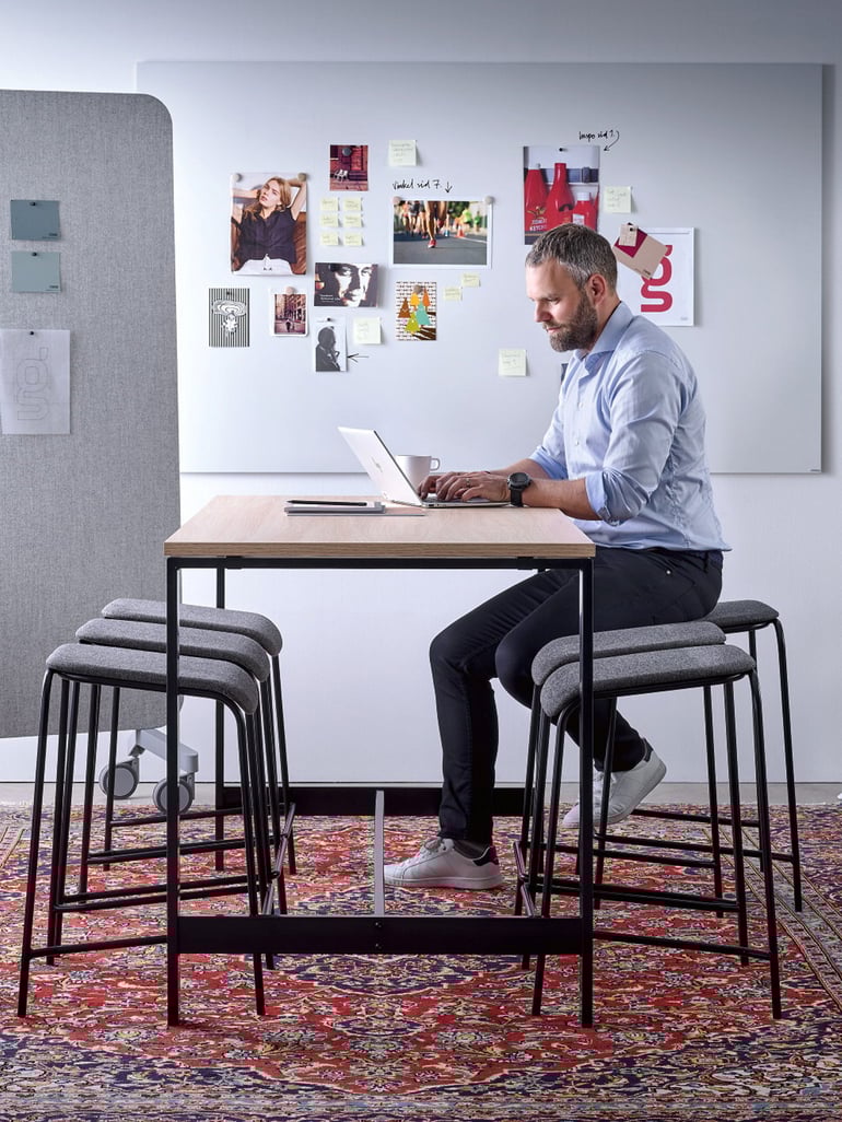 a man working with his laptop in a conference room