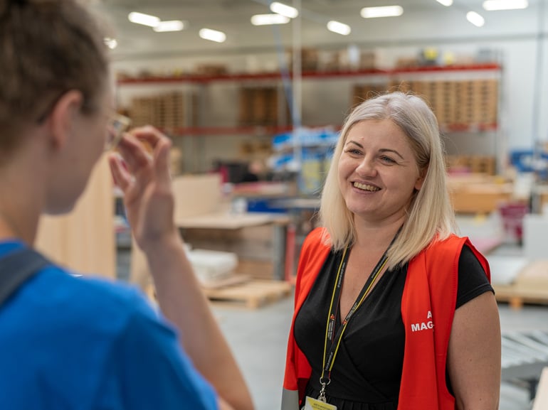 Manager talks to worker on factory floor