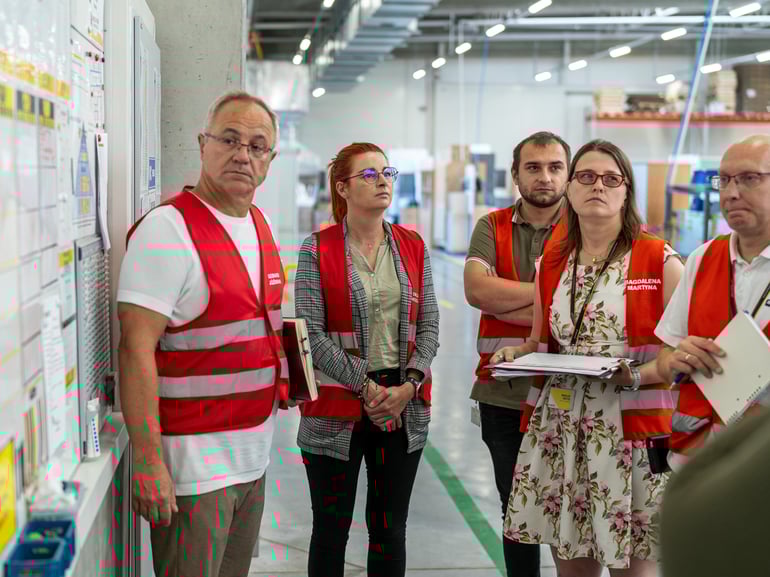 Management team holds a daily meeting on factory floor