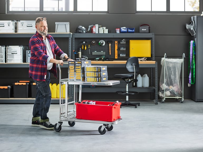 Person pushing a warehouse cart in a warehouse