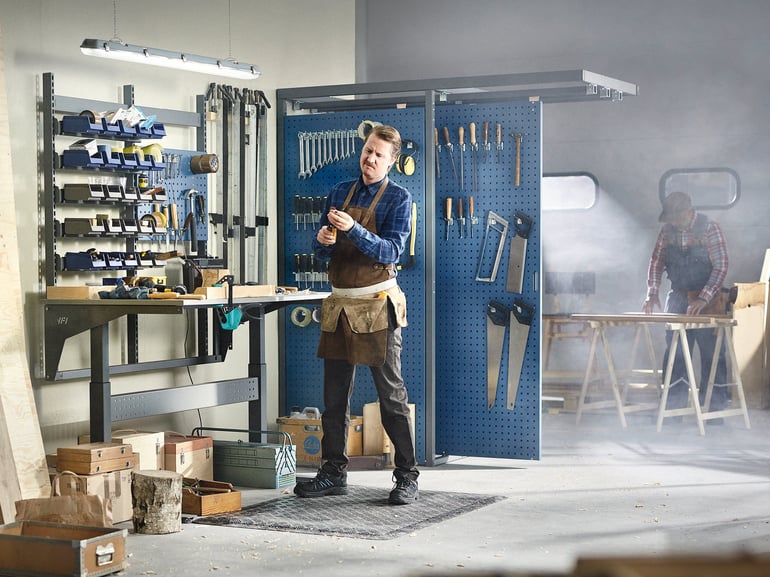 Man standing at a workbench in a workshop