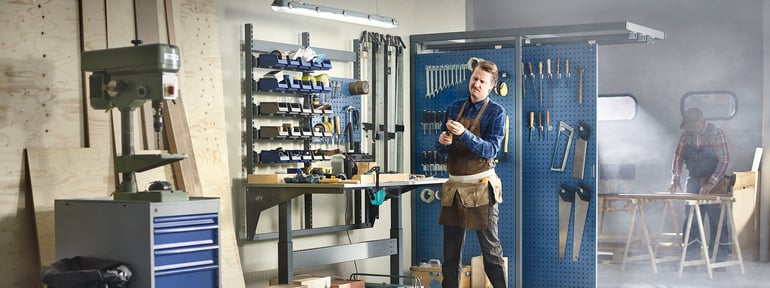 Man standing at a workbench in a workshop