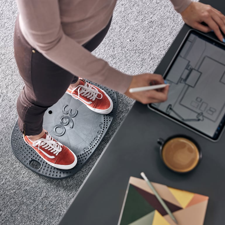 Close up of person standing at a desk