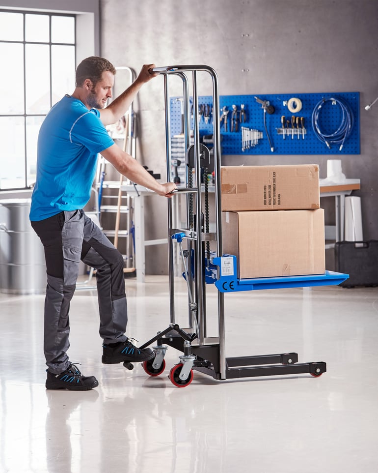 A manual stacker in use in a workshop