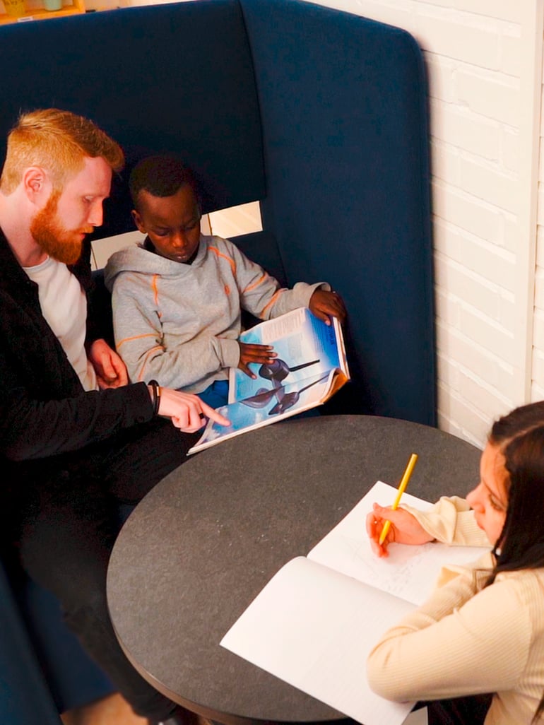 Teacher reading with a young student