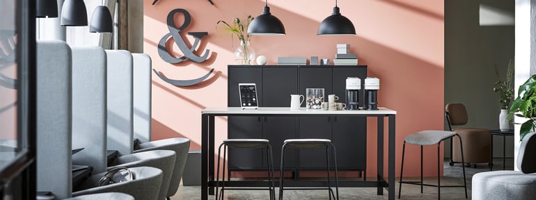 Office reception space with canteen table and individual workspaces