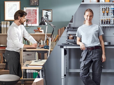 man standing at desk, woman standing at height-adjustable workstation