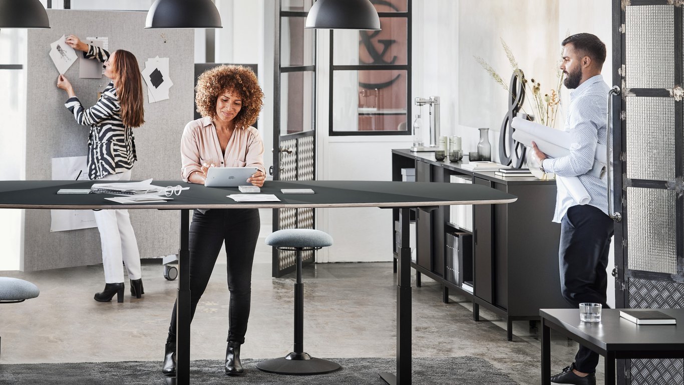 Colleagues standing at a meeting table