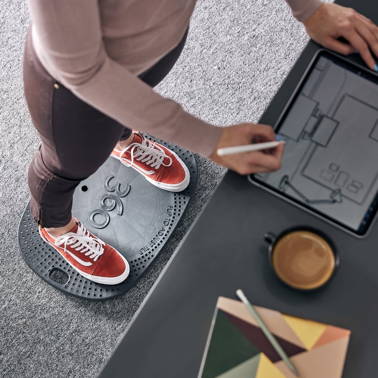 Close up of person standing working at a desk