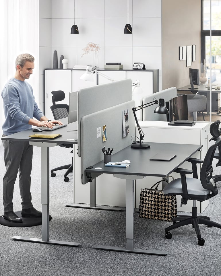 Praca przy komputerze na stojąco przy regulowanym biurku