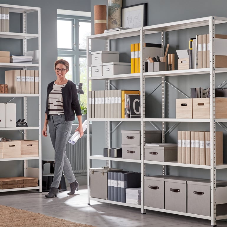 Lighter storage shelves with binders and storage boxes in an office environment