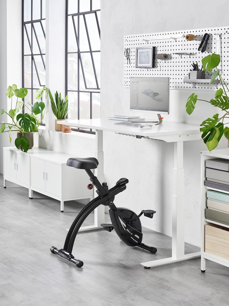 Desk bike at a height adjustable desk