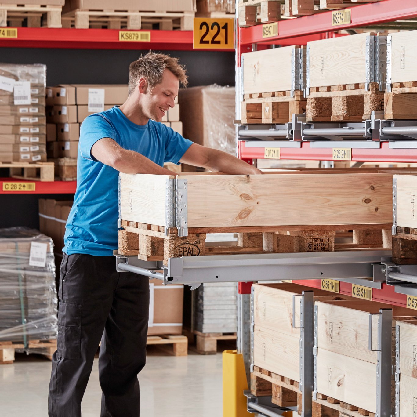 Person loading goods onto pallet on pallet racking