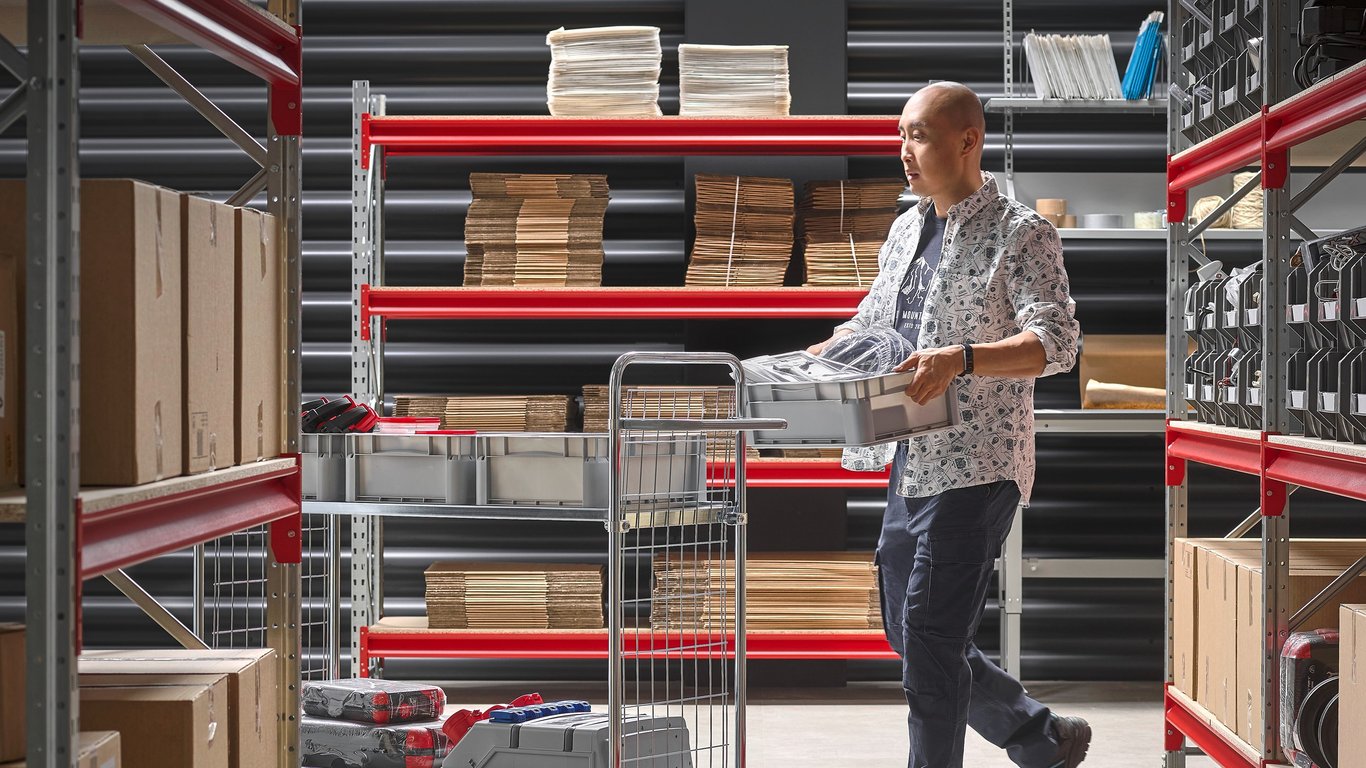 Person with picking trolley in stockroom