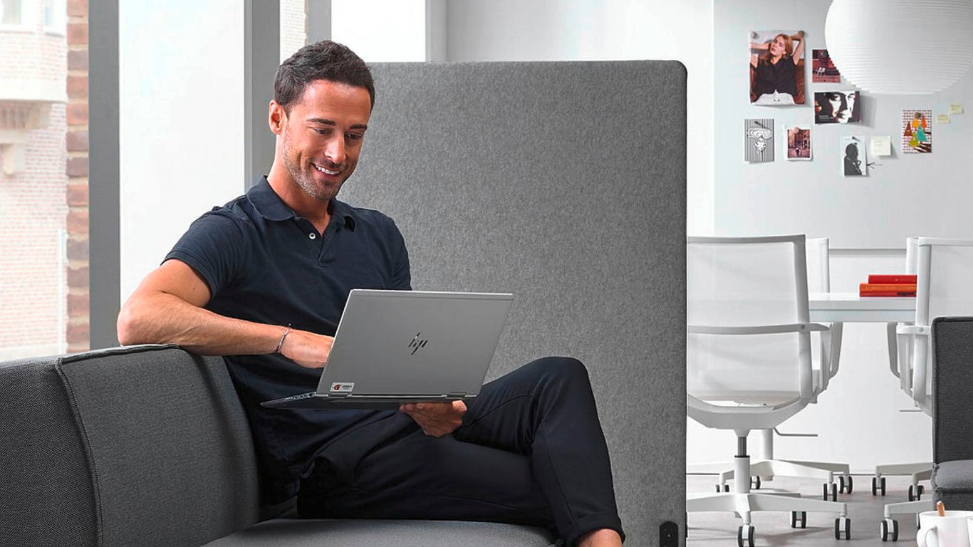 Man sitting on a sofa and working on a laptop