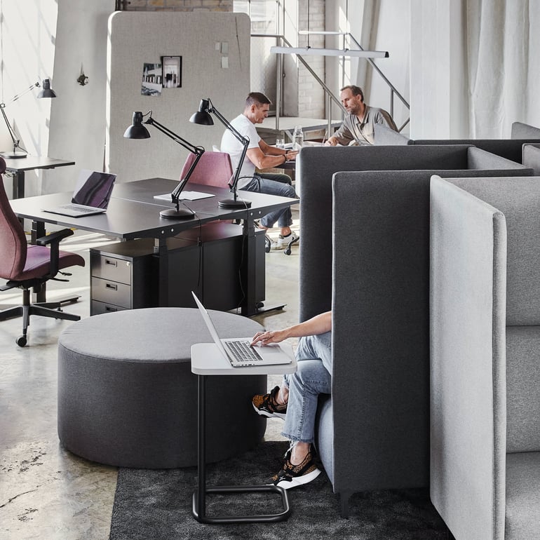 Open plan office with desks and sofas