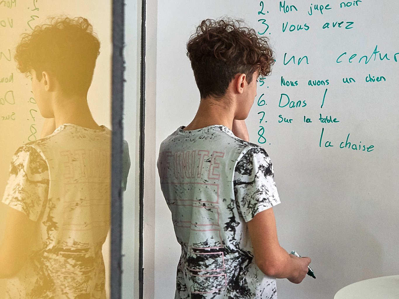 Boy working at a whiteboard