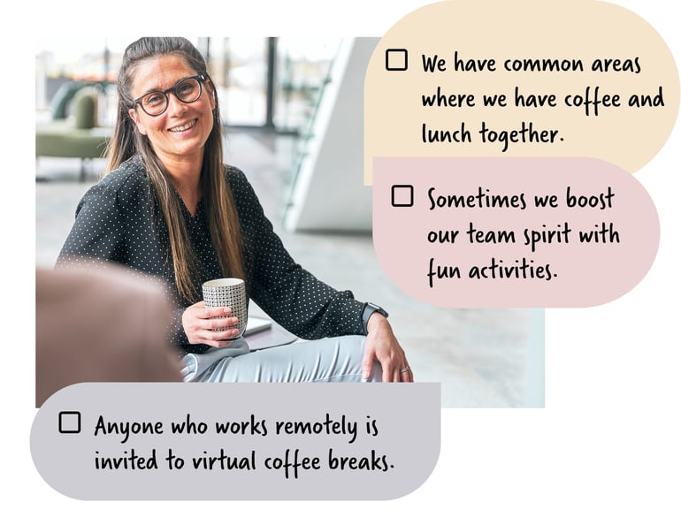 Woman in an office lobby holding a coffee and smiling