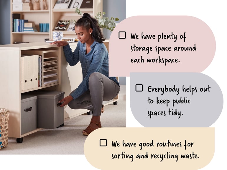 A woman crouching to get a storage box out of a bookcase in an office