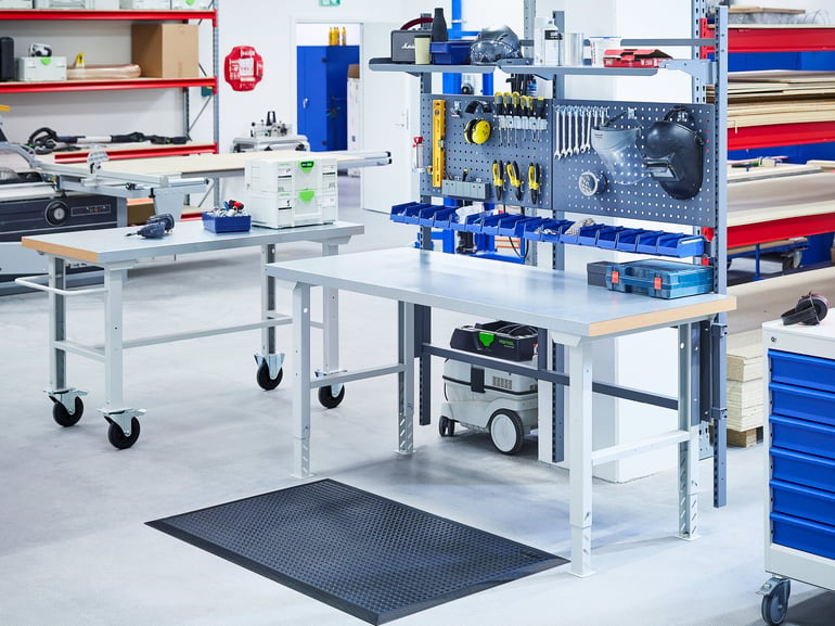 workshop table with tools and shelving