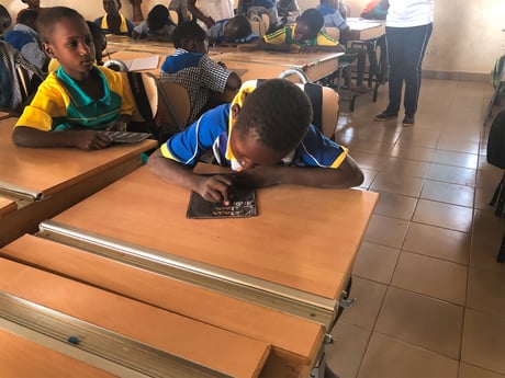 A child works at a classroom desk