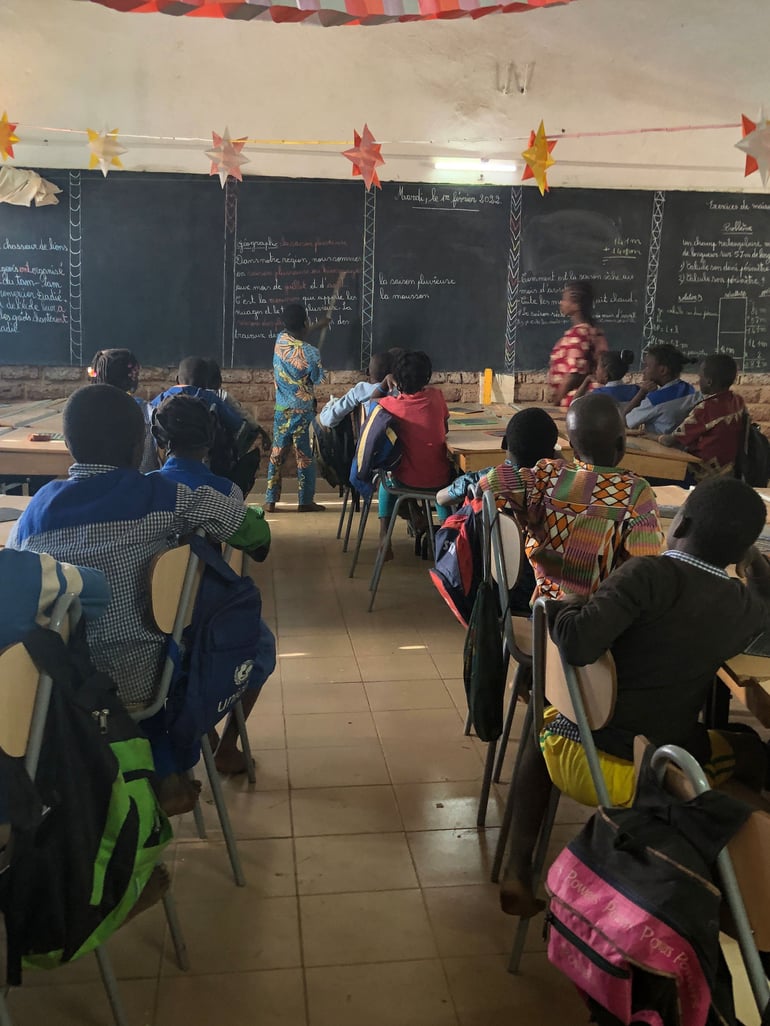 A child writes on a blackboard at a school in Burkina Faso