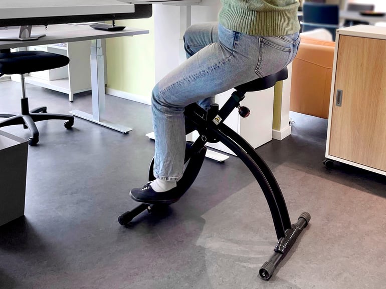 Person cycling on a desk exercise bike