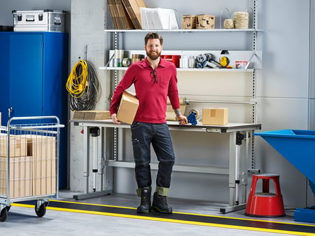 Man standing in front of sit-stand workbench